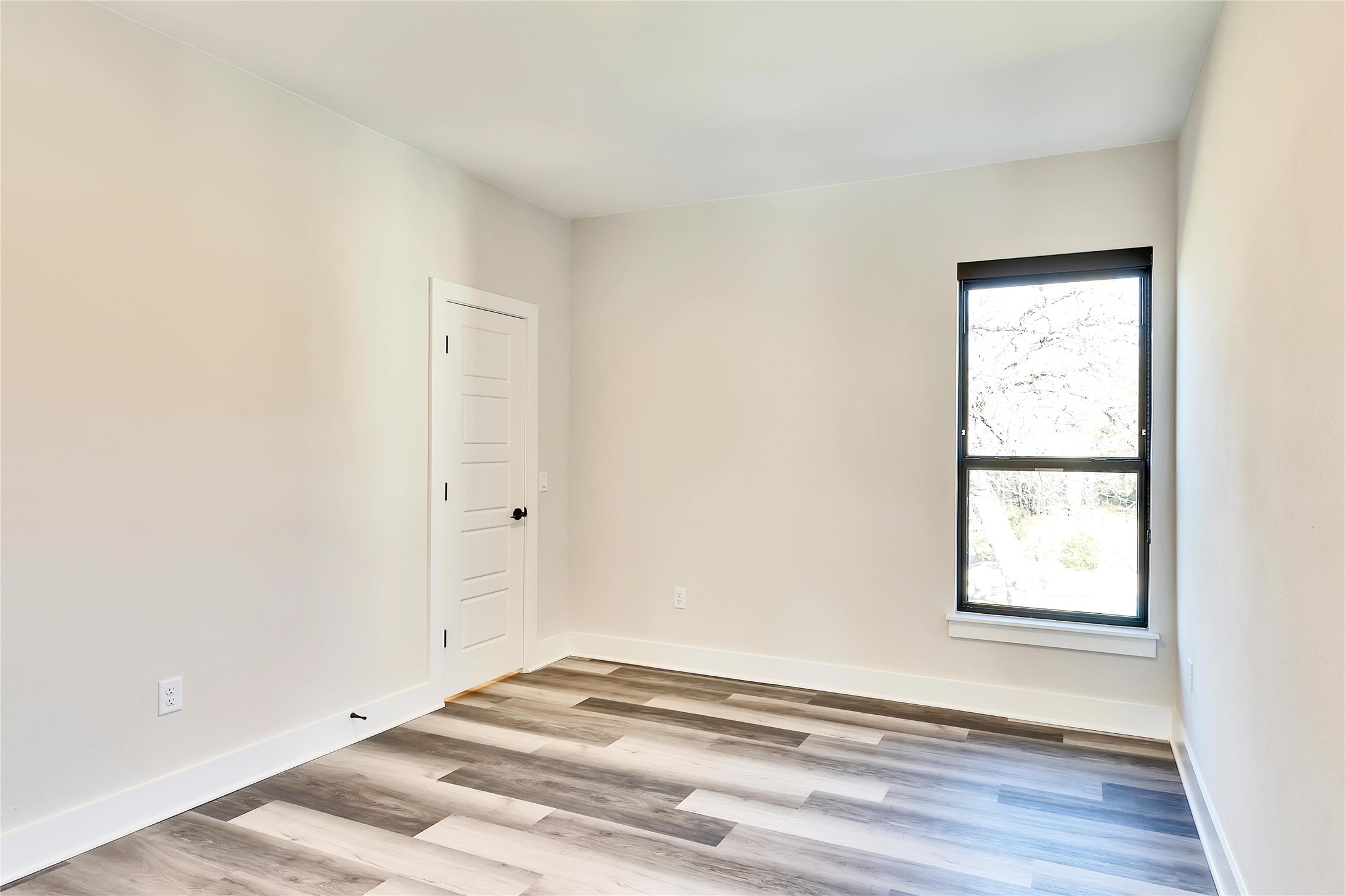 1304 Minnie Drive Austin, TX 78732 - Photo 25 of 28 Spare room with light wood-style floors and baseboards