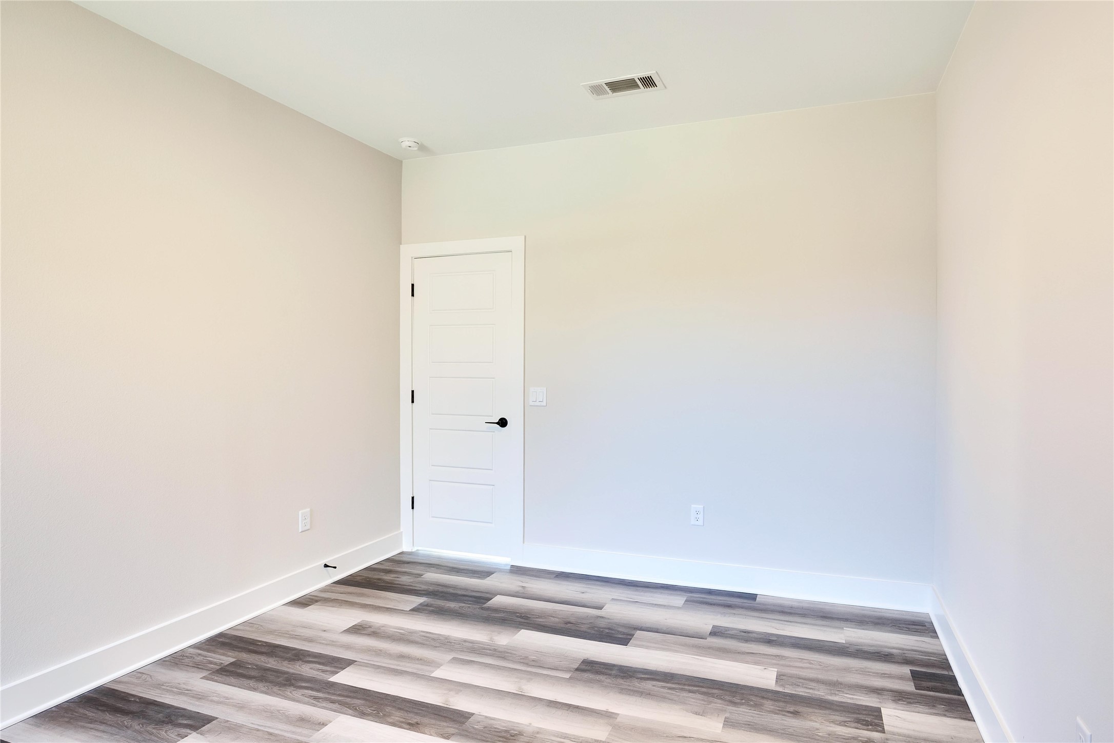 1304 Minnie Drive Austin, TX 78732 - Photo 27 of 28 Spare room featuring light wood-style floors and baseboards