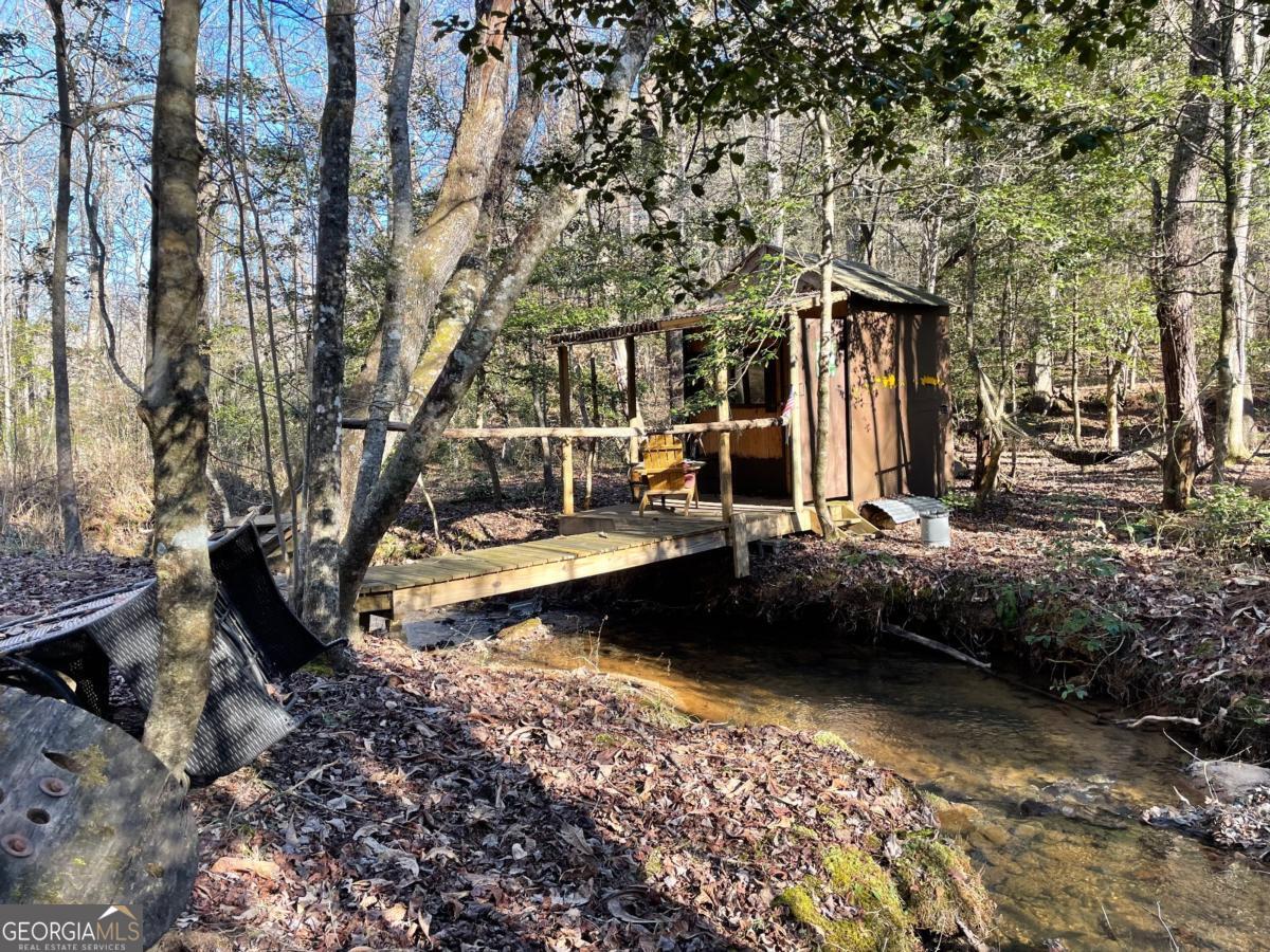 0 Idle Lane Blue Ridge, GA 30513 - Photo 1 of 1 View of yard featuring a camping shed and bridge across creek.