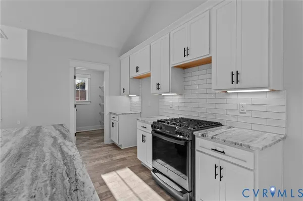 a kitchen with a sink stove top oven and cabinets