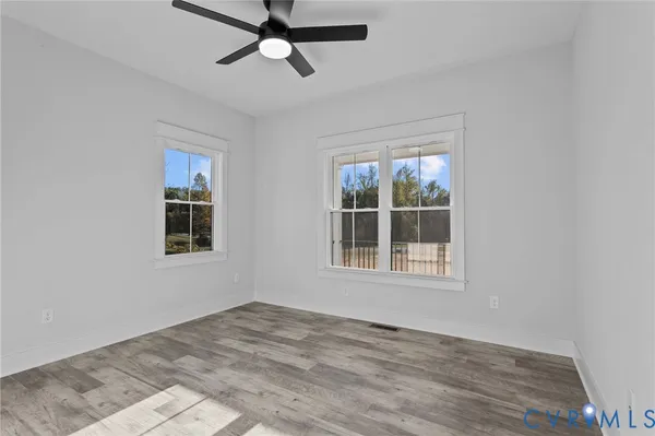 wooden floor in an empty room with a window