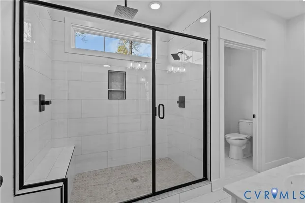 a bathroom with a double vanity sink and mirror with shower