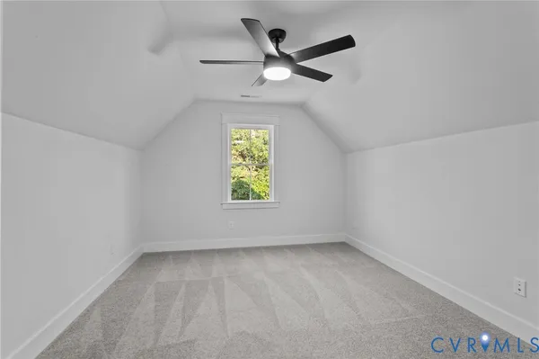 an empty room with a ceiling fan and a fan