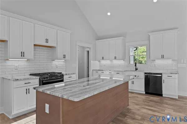 a kitchen with a stove a sink and a refrigerator