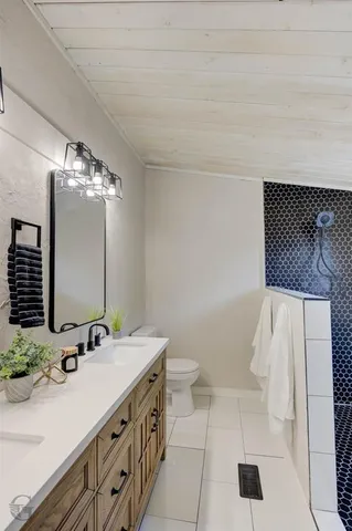 a bathroom with a sink a toilet and mirror