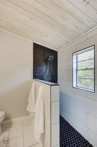 a bathroom with a bathtub and shower