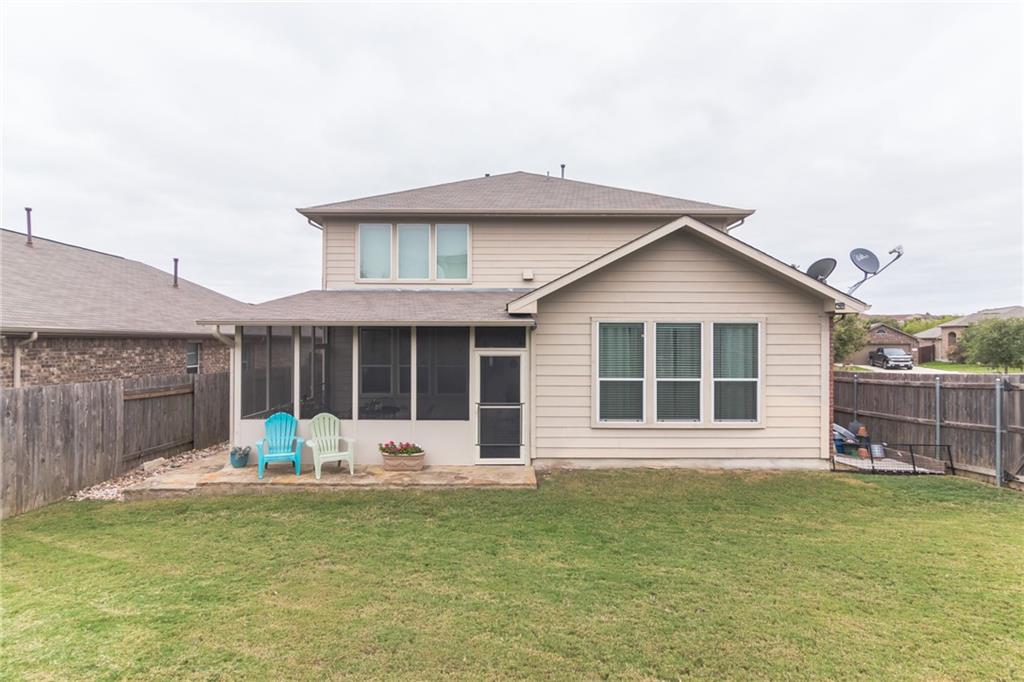 252 Pond View Pass Buda, TX 78610 - Photo 28 of 37 Back of property featuring a sunroom and a fenced backyard