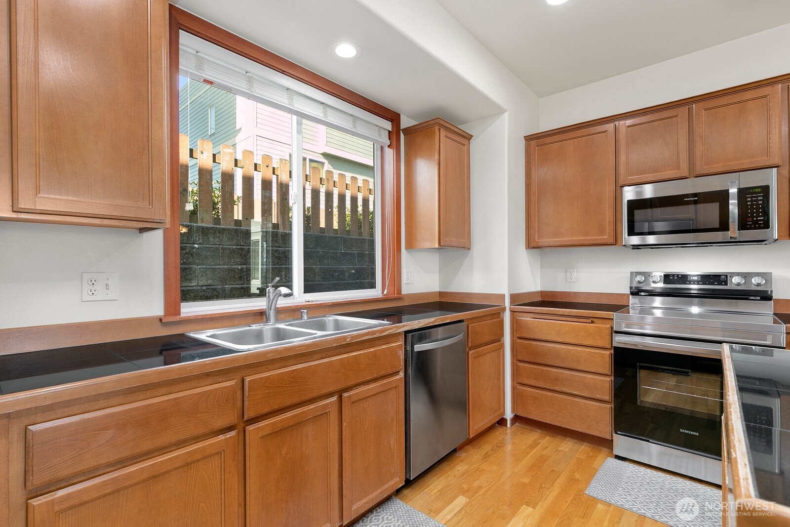 1132 Chestnut Street Everett, WA 98201 - Photo 11 of 24 a kitchen with stainless steel appliances granite countertop a stove a sink and a microwave