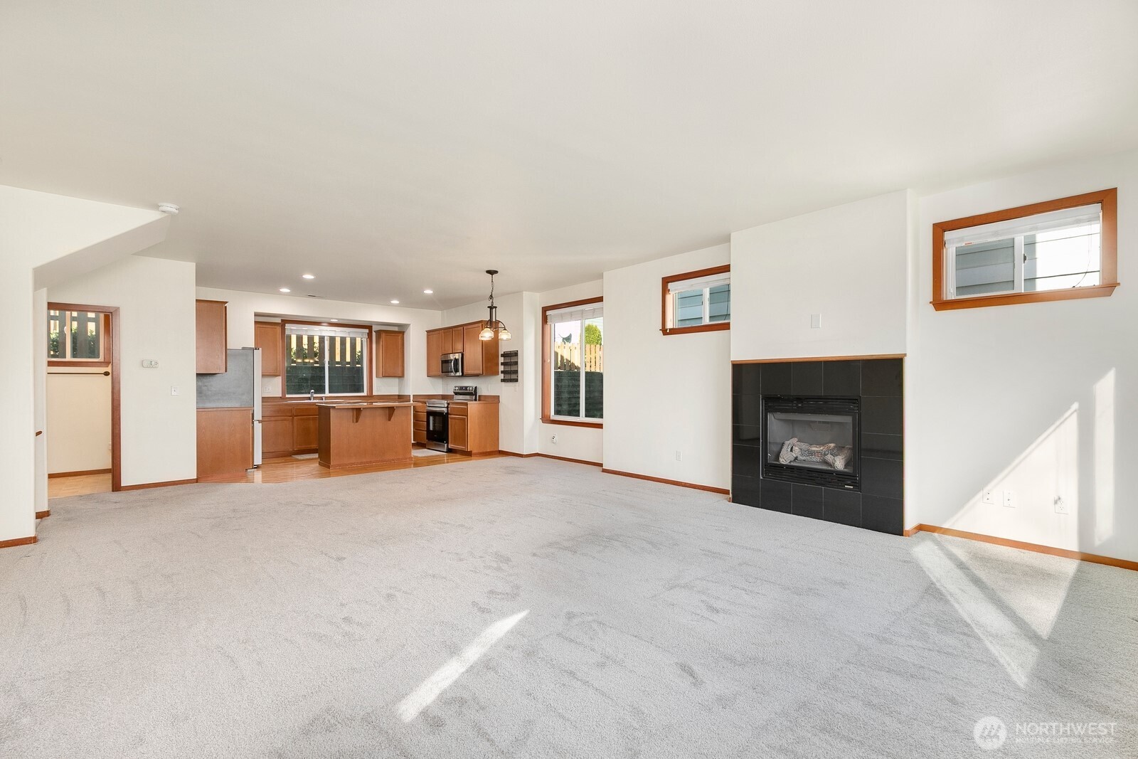 1132 Chestnut Street Everett, WA 98201 - Photo 7 of 24 a view of an empty room with a fireplace and a window