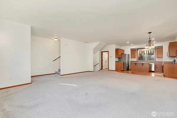 a kitchen with stainless steel appliances granite countertop a refrigerator a stove top oven a sink and dishwasher