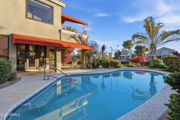 an aerial view of house with yard swimming pool and outdoor seating
