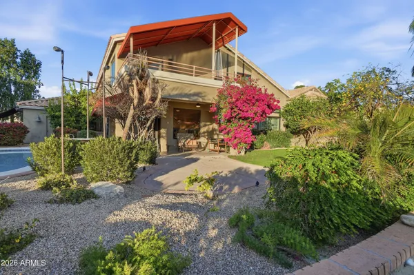 a front view of a house with a garden and plants