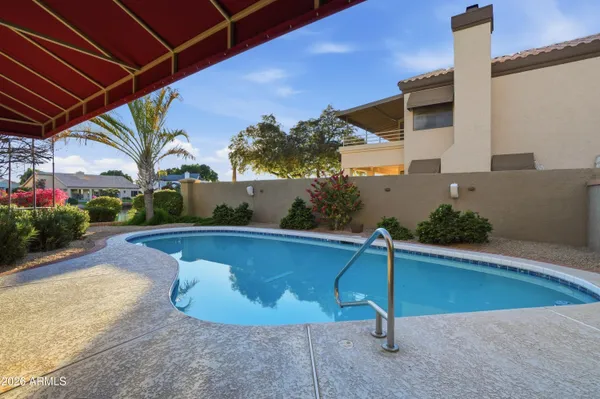 a bathroom with a granite countertop tub sitting next to a large window