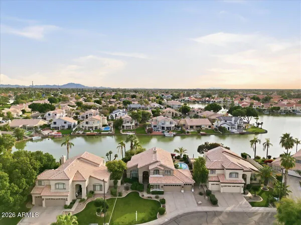 a bathroom with a toilet a sink a tub and mirror