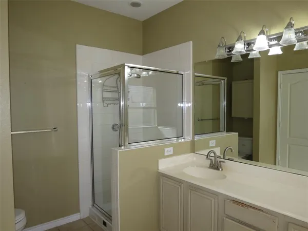 a bathroom with a sink vanity and a mirror