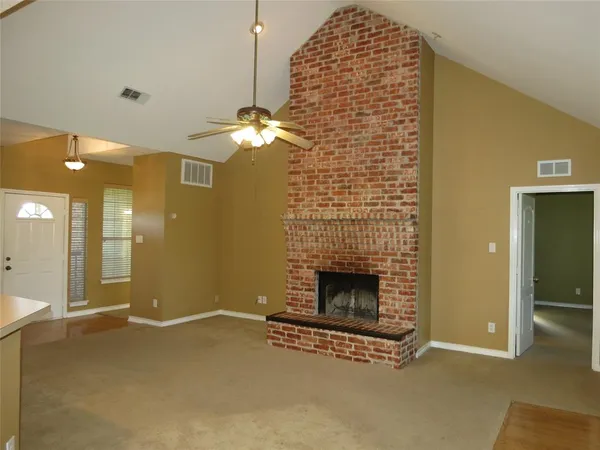 a view of an empty room with a fireplace