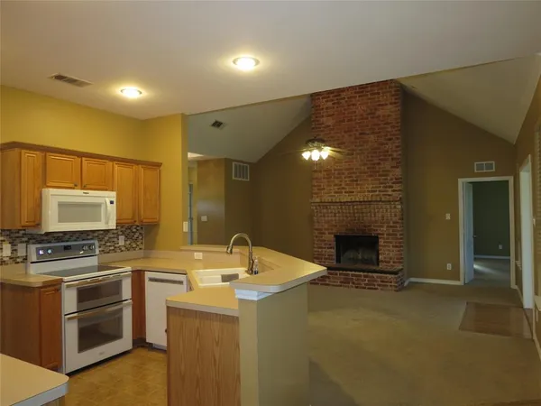 a kitchen with stainless steel appliances a stove sink and microwave