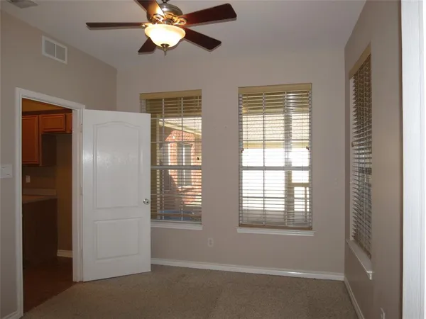 a view of a livingroom with a ceiling fan and window