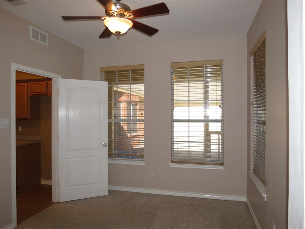 109 Country View Lane Fate, TX 75189 - Photo 6 of 24 a view of a livingroom with a ceiling fan and window