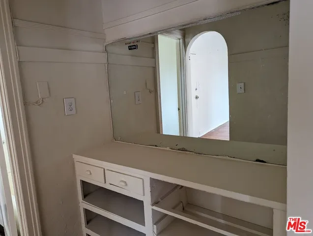 a bathroom with a sink toilet and a mirror