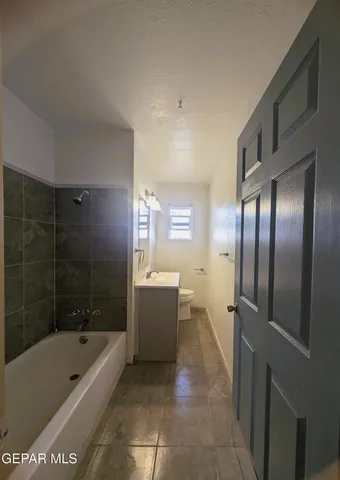 a bathroom with a bathtub a shower a toilet and sink