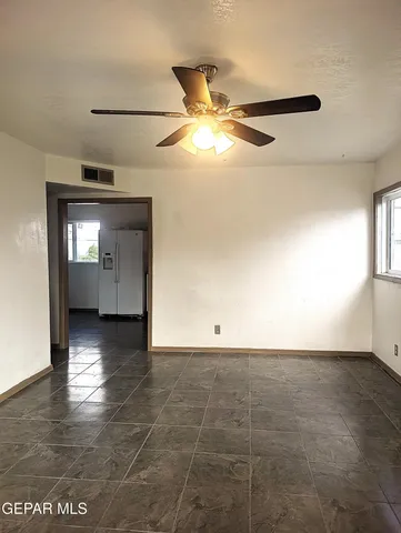 an empty room with windows and entrance