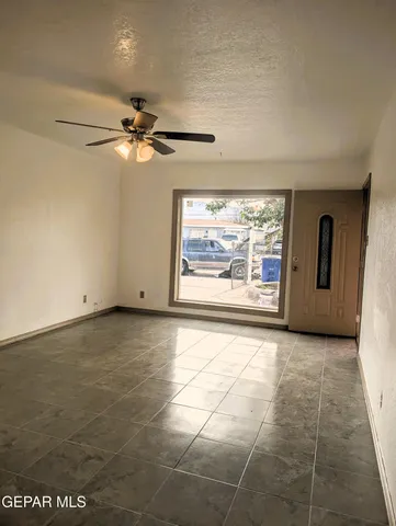 a view of an empty room with glass door