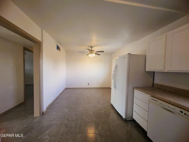 a view of a kitchen with refrigerator and cabinet
