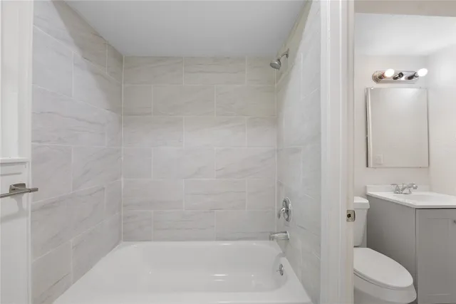 a bathroom with a sink toilet and vanity