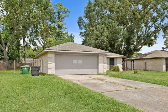 a front view of house with yard and trees