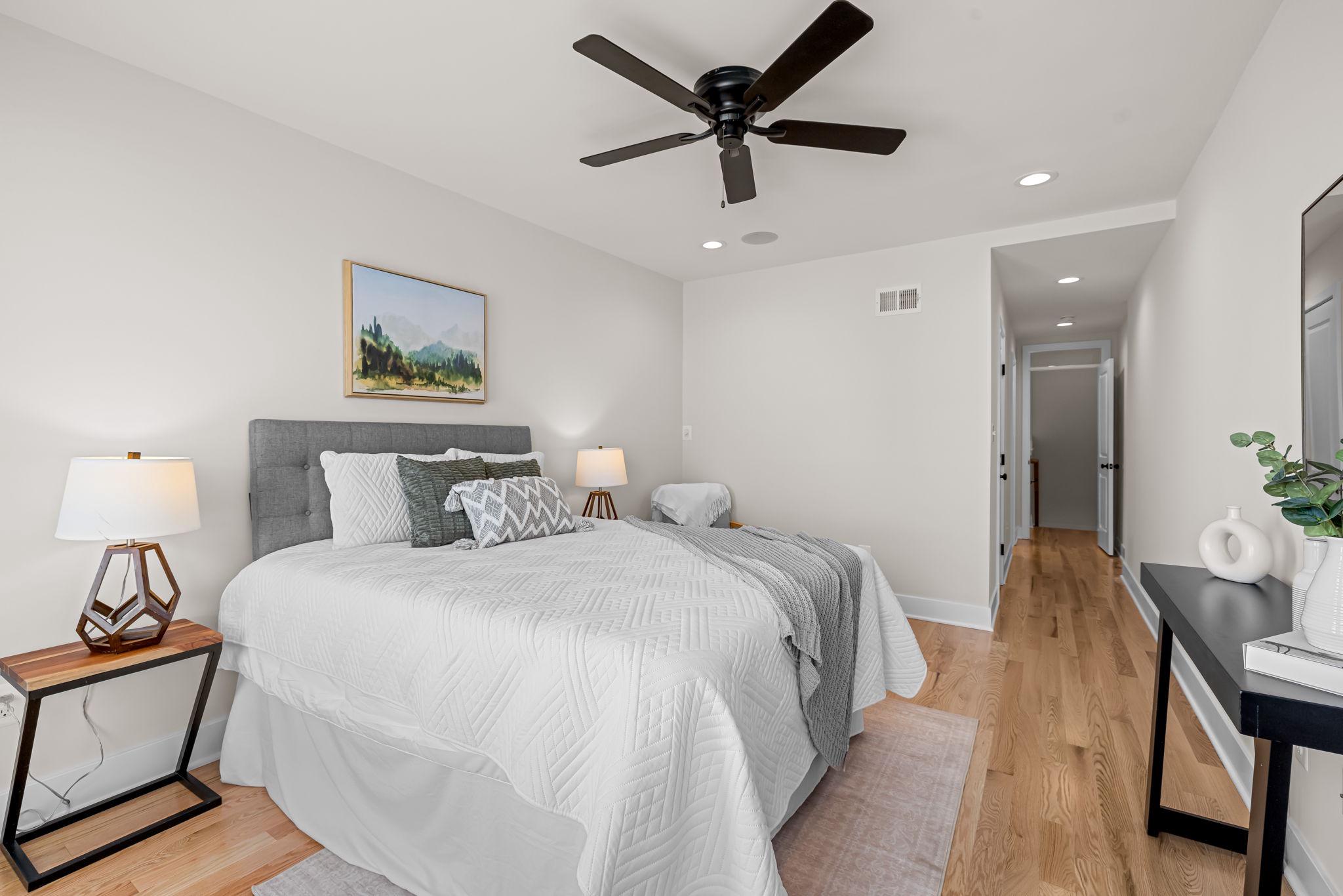 22 South Castle Street Baltimore, MD 21231 - Photo 22 of 32 a spacious bedroom with a bed and a chandelier