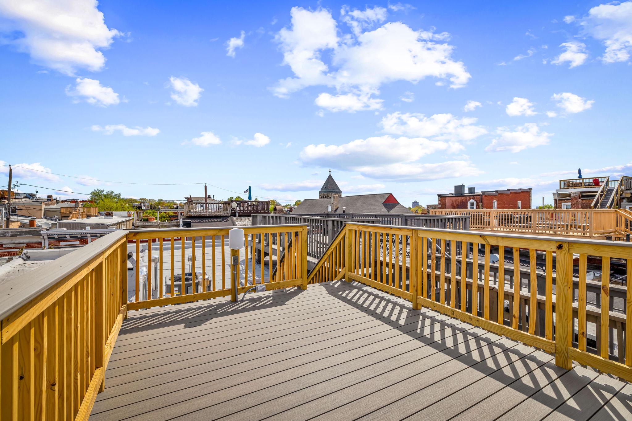 22 South Castle Street Baltimore, MD 21231 - Photo 27 of 32 a view of roof deck with two chairs and wooden floor