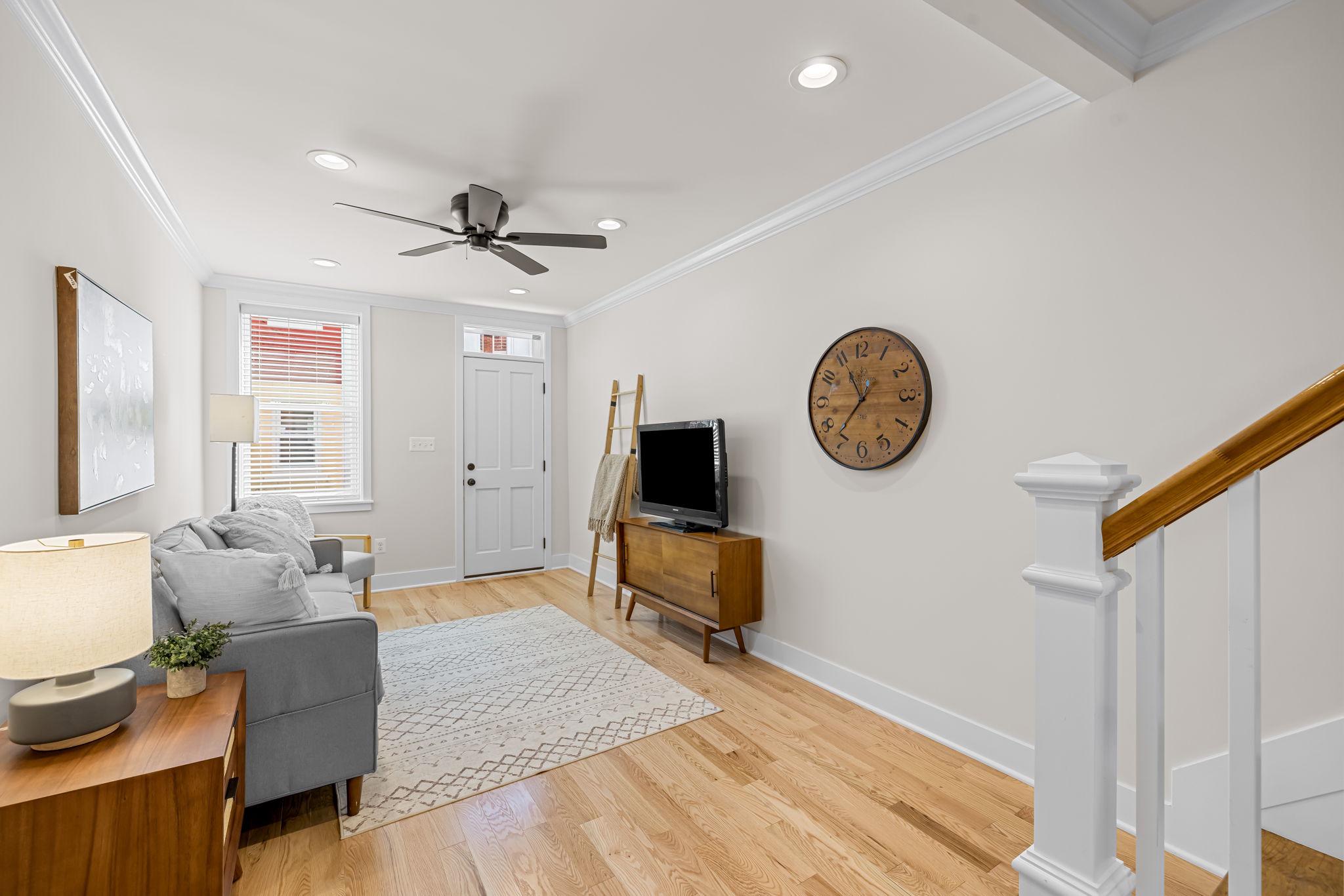 22 South Castle Street Baltimore, MD 21231 - Photo 6 of 32 a living room with furniture a clock on wall and a window