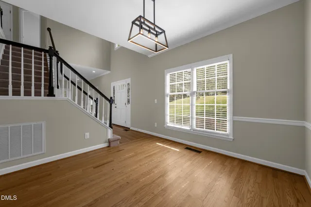 a view of entryway and hall with wooden floor