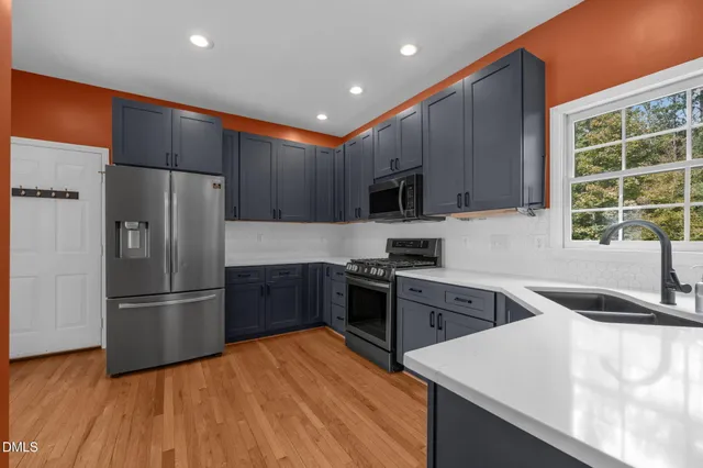a view of kitchen with cabinets and wooden floor