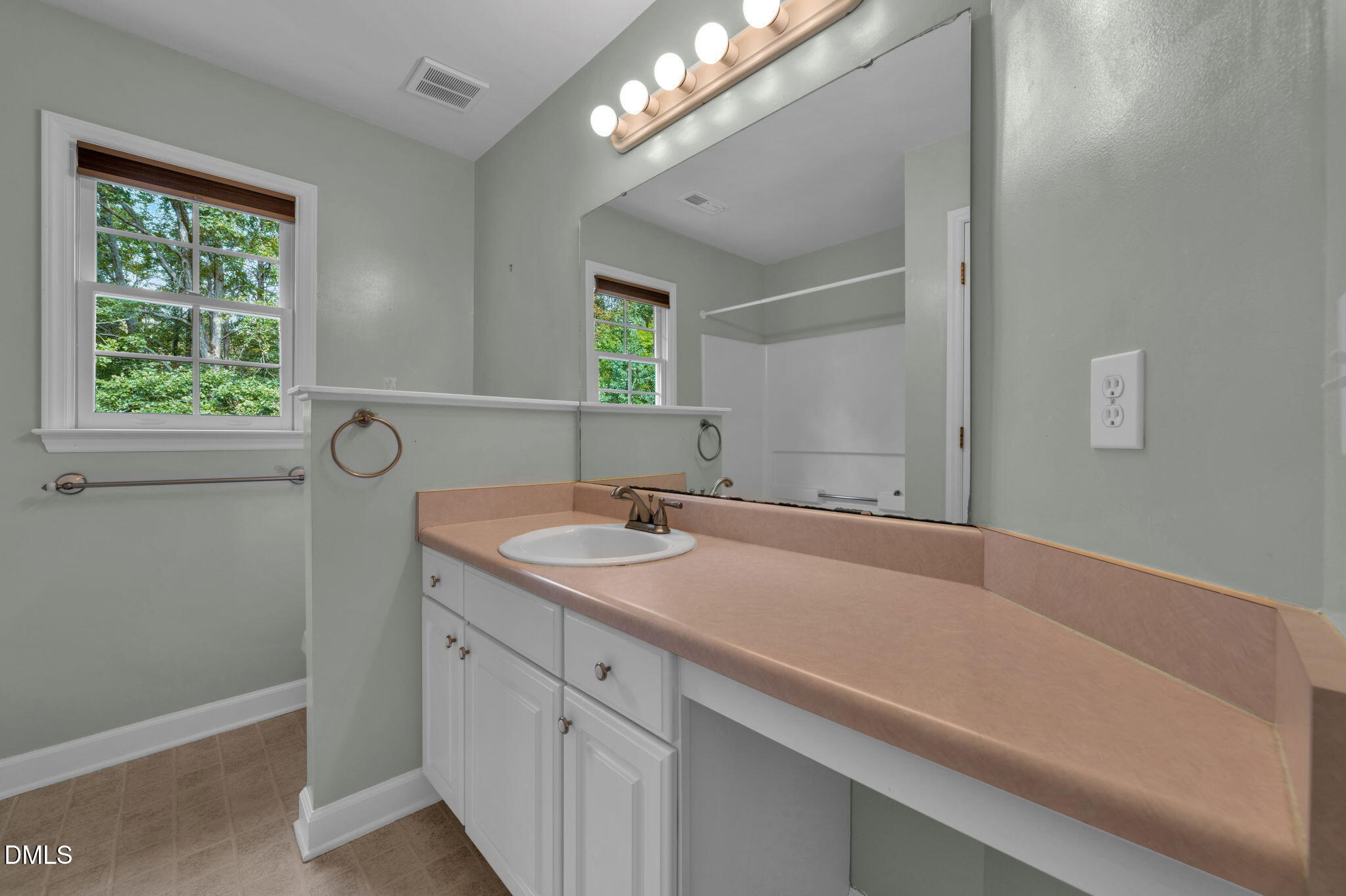16 Quail Hunt Circle Durham, NC 27712 - Photo 34 of 61 a bathroom with a sink and a mirror