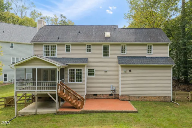 an aerial view of residential houses with outdoor space and trees