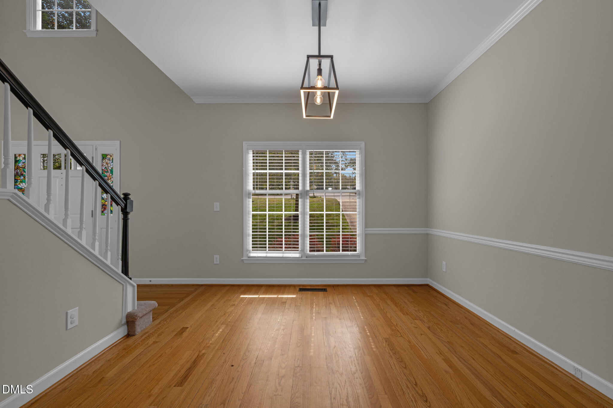 16 Quail Hunt Circle Durham, NC 27712 - Photo 8 of 61 a view of an empty room with wooden floor and a window