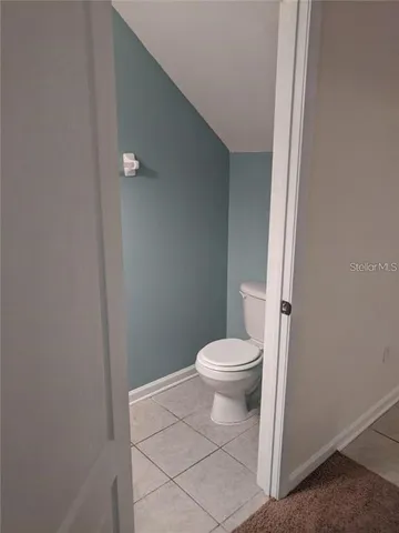 a white toilet sitting next to a shower