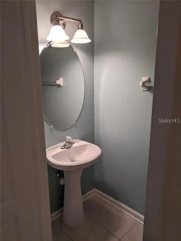 a bathroom with a sink and mirror