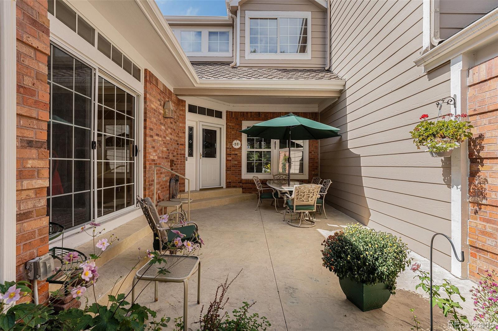 a backyard of a house with outdoor seating
