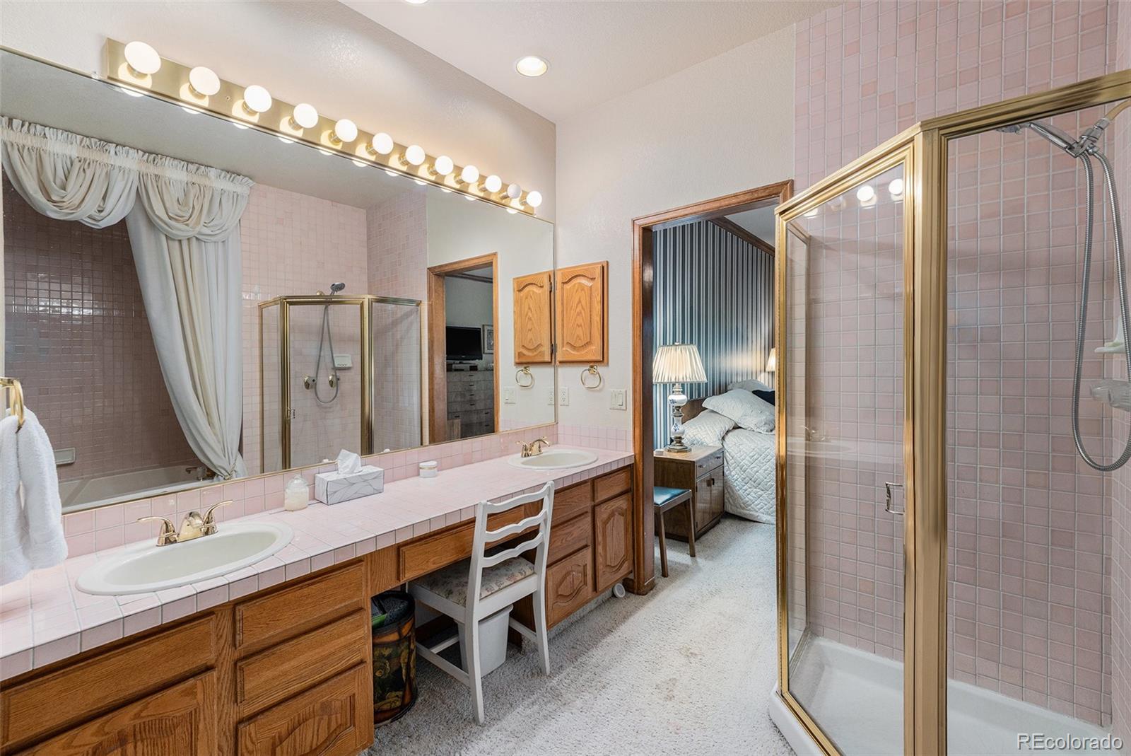 9873 Greensview Circle Lone Tree, CO 80124 - Photo 19 of 27 a bathroom with a double vanity sink mirror and shower