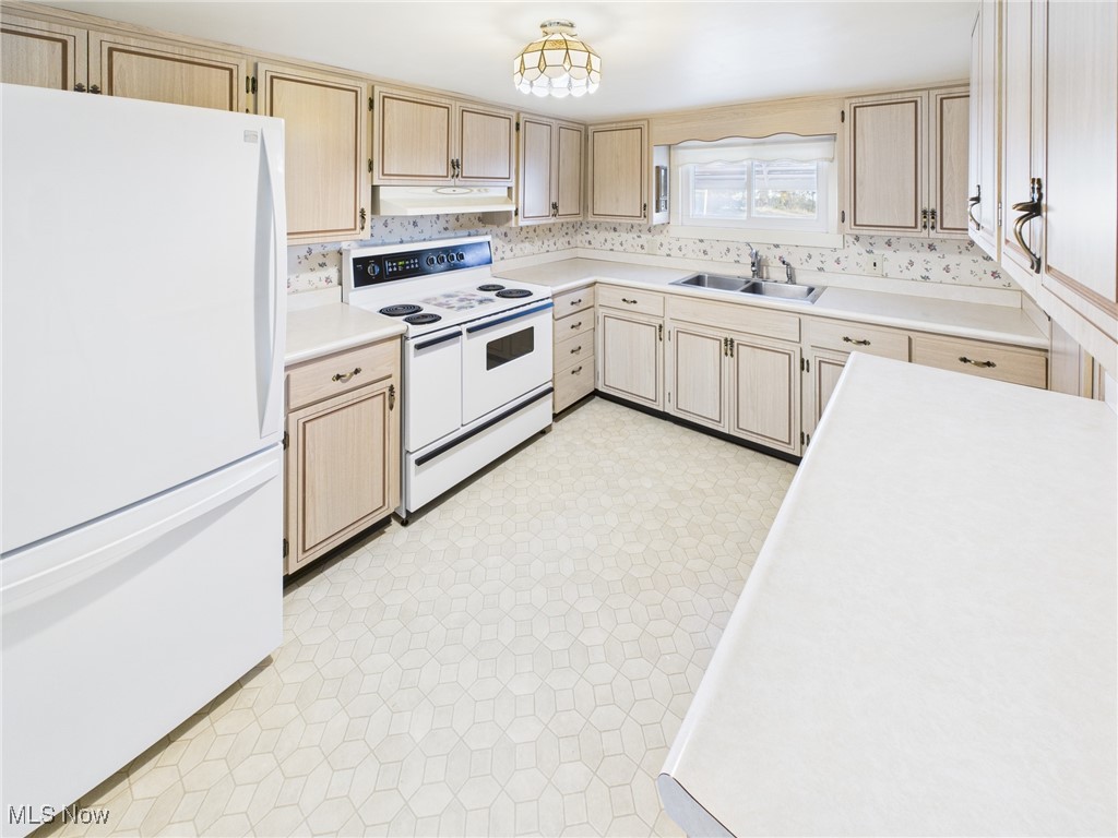 207 Stone Oak Road Davisville, WV 26142 - Photo 4 of 22 Kitchen with white appliances, light brown cabinets, light countertops, and under cabinet range hood