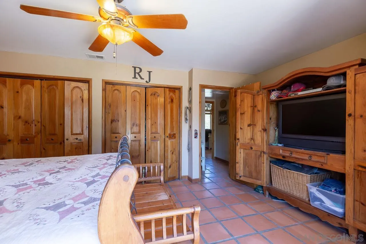 2029 Willow Glen Road Fallbrook, CA 92028 - Photo 14 of 46 a bedroom with a bed and a television