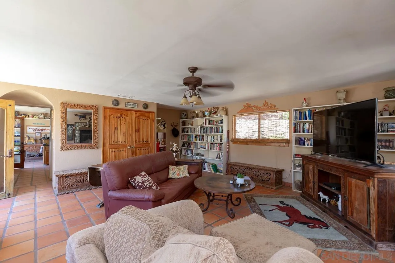 2029 Willow Glen Road Fallbrook, CA 92028 - Photo 6 of 46 a living room with furniture and a flat screen tv