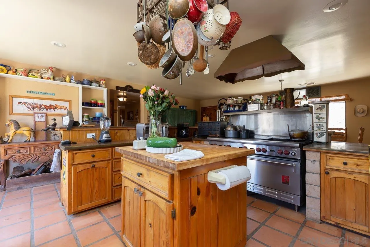 2029 Willow Glen Road Fallbrook, CA 92028 - Photo 9 of 46 a kitchen with a stove cabinets and chandelier