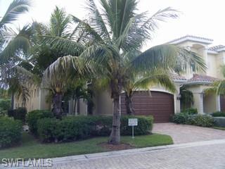 5738 Mango Circle, Unit 5738 Naples, FL 34110 - Photo 2 of 8 a view of a house with a tree and plants