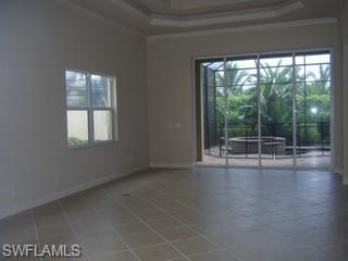 5738 Mango Circle, Unit 5738 Naples, FL 34110 - Photo 3 of 8 a view of a room with wooden floor and windows