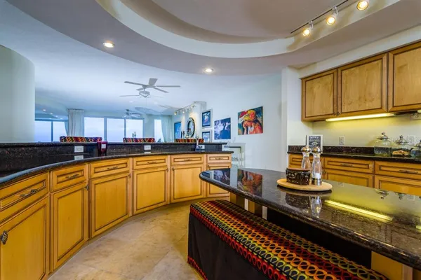 a living room with furniture ceiling fan and a rug