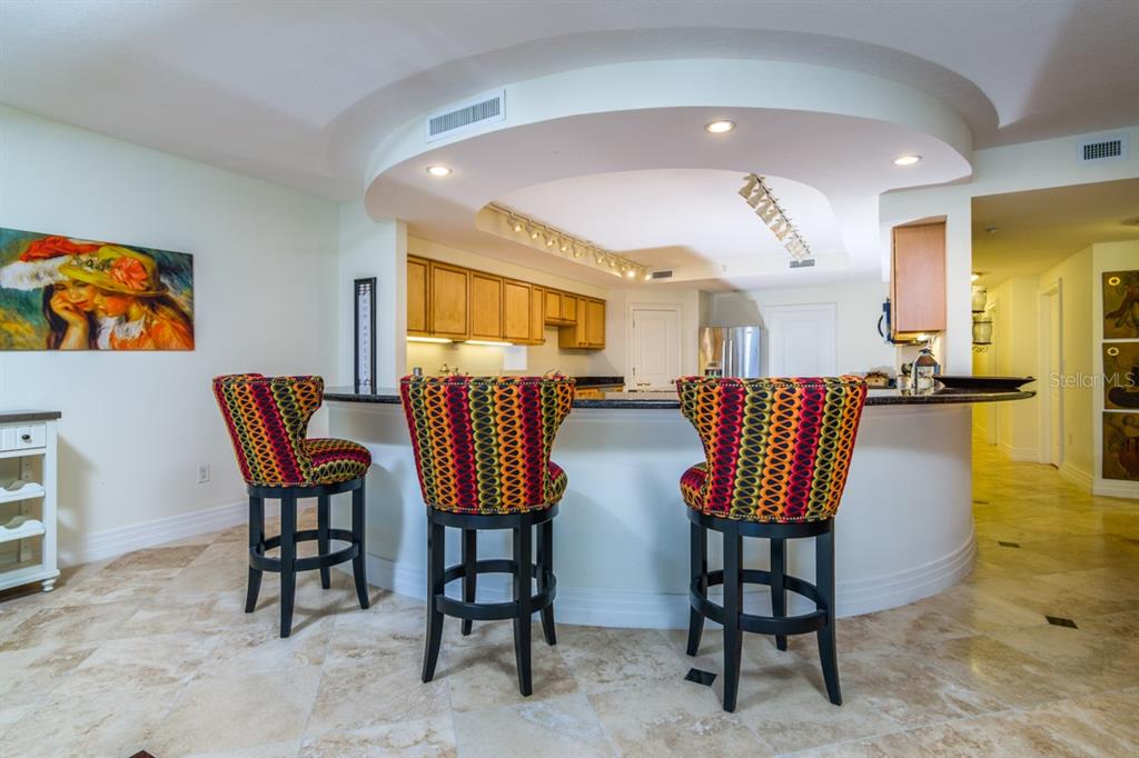 1350 Gulf Boulevard, Unit 901 Clearwater Beach, FL 33767 - Photo 25 of 63 a view of a dining room with furniture and a kitchen